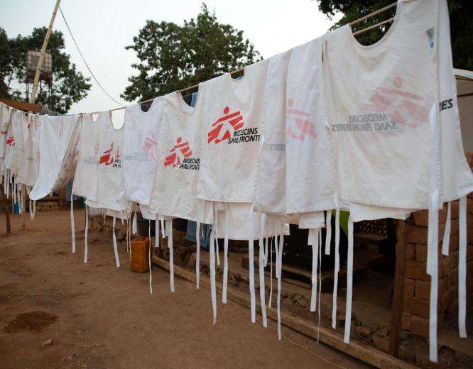 White vests with MSF logo hanging on a clothesline