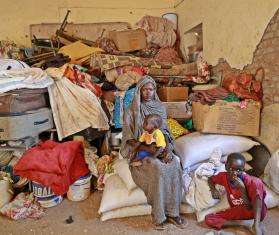Displaced Sudanese woman with her children in Wad Madani, Sudan.