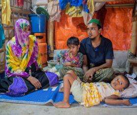 A Rohingya refugee family inside their shelter.