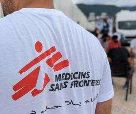 Person wearing a white T-shirt with Doctors Without Borders logo on the back